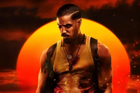 Michael B. Jordan jako John Kelly w filmie "Grzesznicy". W tle wielkie, pomarańczowe słońce.