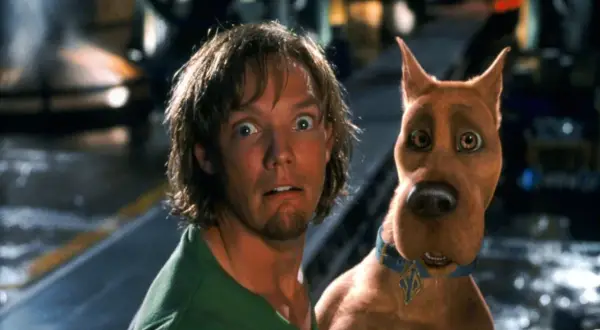 Przerażeni Shaggy i Scooby-Doo wpadają na siebie, gdy uciekają przed potworem.