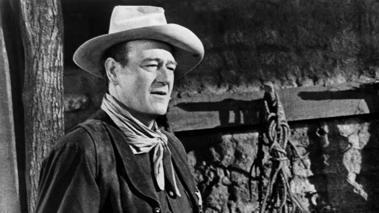 John Wayne w kapeluszu i chustce, ikona westernu, jako część obsady filmu 
