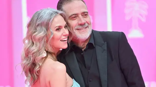 Jeffrey Dean Morgan, znany z filmów, seriali i programów, uśmiecha się do swojej żony na różowym tle.